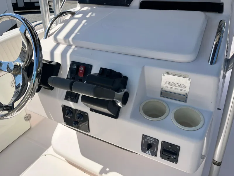 Slide: The Image of 2003 Grady-White Chase 273 boat console with steering wheel and controls. - 20
