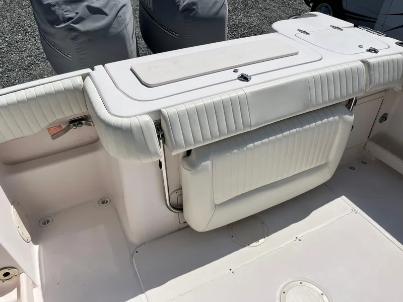 Slide: The Image of 2003 Grady-White Chase 273 boat interior with cushioned seating and storage. - 25
