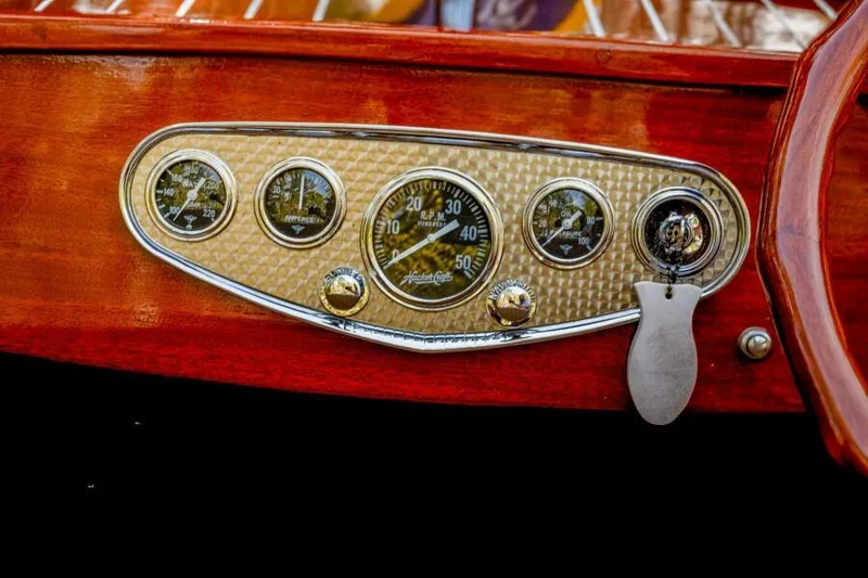 Slide: The Image of 1941 Hacker-Craft Deluxe dashboard with vintage gauges and wooden finish. - 12