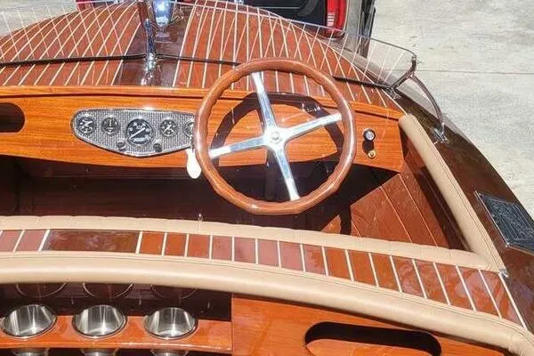 Slide: The Image of 1941 Hacker-Craft Deluxe boat interior with wooden dashboard and steering wheel. - 16