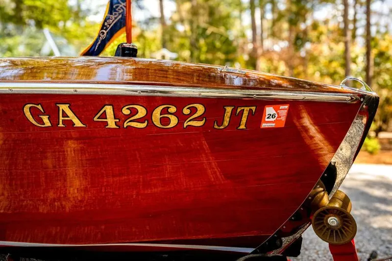 Slide: The Image of 1941 Hacker-Craft Deluxe boat with registration GA 4262 JT, displayed outdoors. - 18