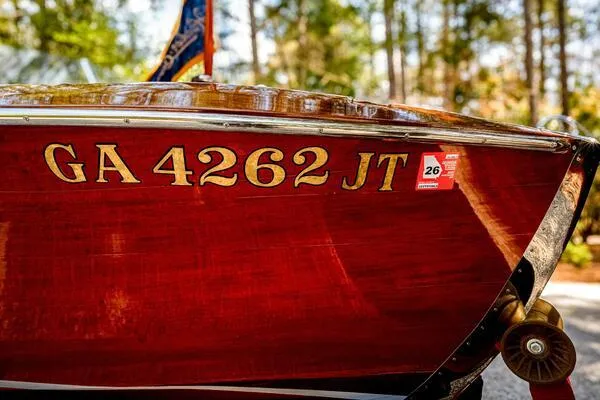 Slide: The Image of 1941 Hacker-Craft Deluxe boat with registration GA 4262 JT, displayed outdoors. - 27