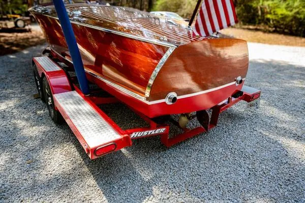 Slide: The Image of 1941 Hacker-Craft Deluxe boat on red trailer with American flag. - 34