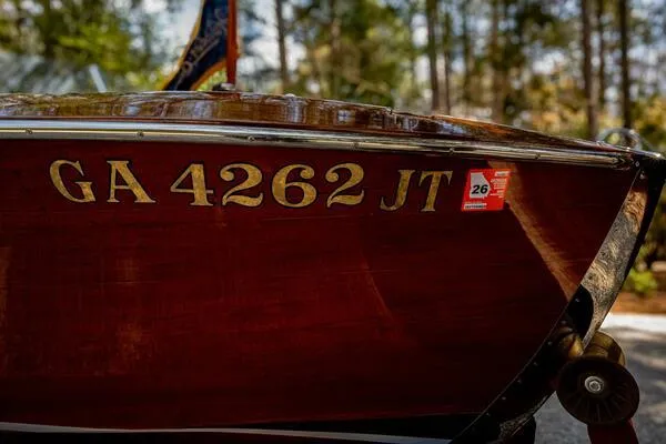 Slide: The Image of 1941 Hacker-Craft Deluxe boat with registration GA 4262 JT, displayed outdoors. - 41