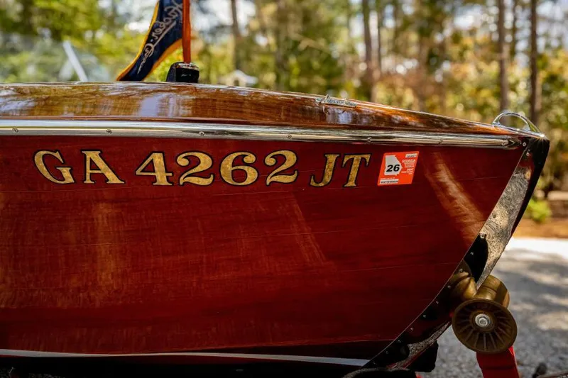 Slide: The Image of 1941 Hacker-Craft Deluxe boat with registration GA 4262 JT, displayed outdoors. - 44