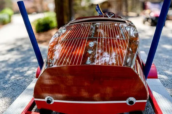 Slide: The Image of 1941 Hacker-Craft Deluxe boat with polished wood finish on a trailer. - 5