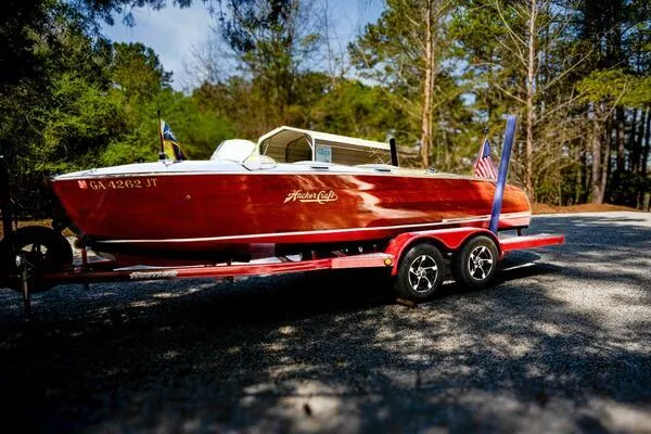 Slide: The Image of 1941 Hacker-Craft Deluxe boat on trailer, surrounded by trees. - 7