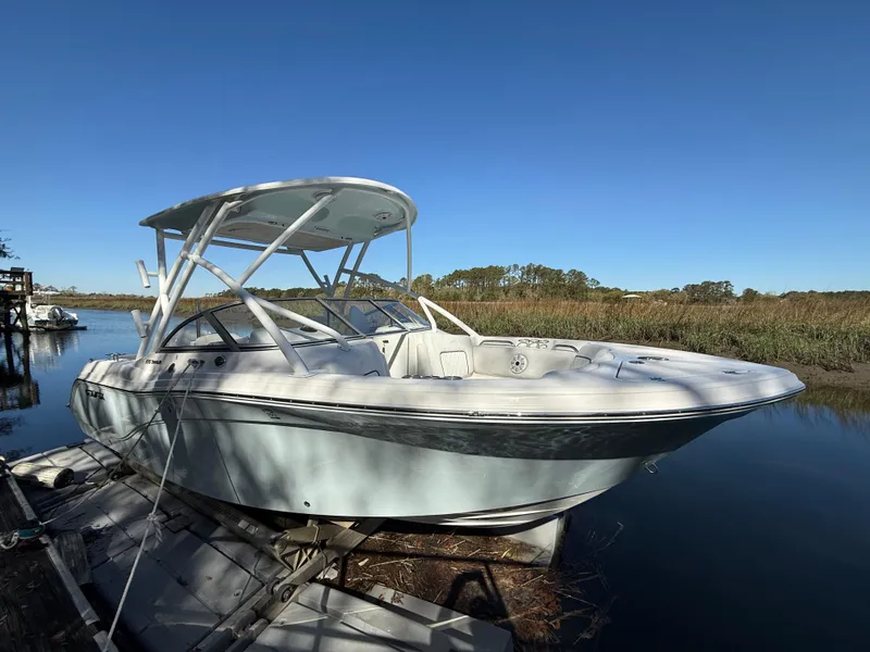 Slide: The Image of 2020 Sea Fox 226 Traveler boat docked on calm water under clear blue sky. - 0
