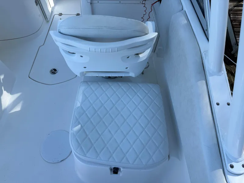 Slide: The Image of 2020 Sea Fox 226 Traveler boat interior with white cushioned seating. - 11