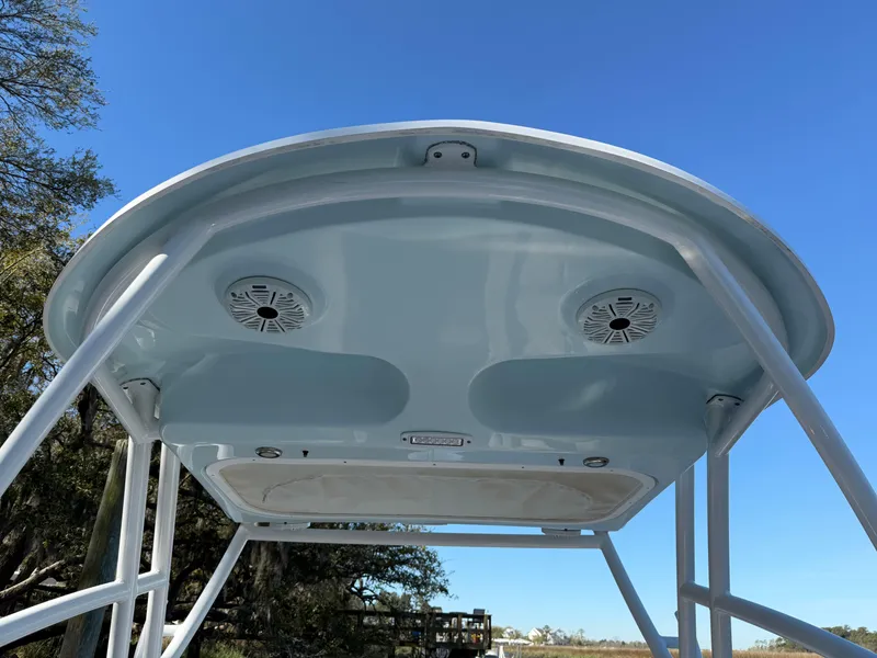 Slide: The Image of T-top of 2020 Sea Fox 226 Traveler boat with speakers, under clear blue sky. - 19