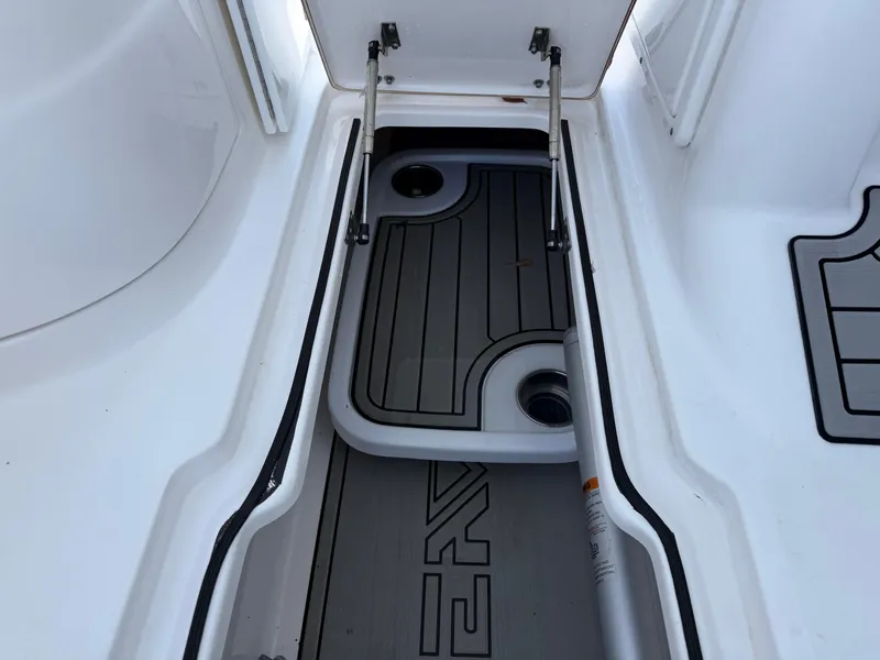 Slide: The Image of 2020 Sea Fox 226 Traveler storage compartment with open hatch and hydraulic supports. - 21