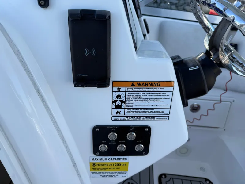 Slide: The Image of Control panel of 2020 Sea Fox 226 Traveler boat with warning labels and capacity information. - 7