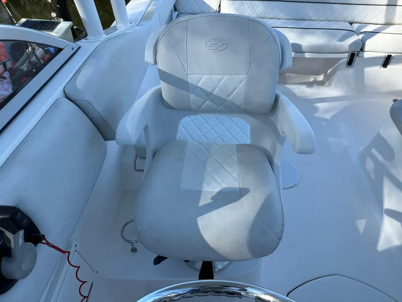 Slide: The Image of Captain's chair on 2020 Sea Fox 226 Traveler boat, featuring cushioned seating and armrests. - 8