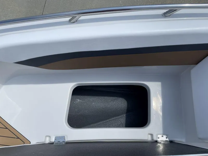 Slide: The Image of 2025 Starcraft SVX 171 OB boat storage compartment with sleek white and black design. - 12