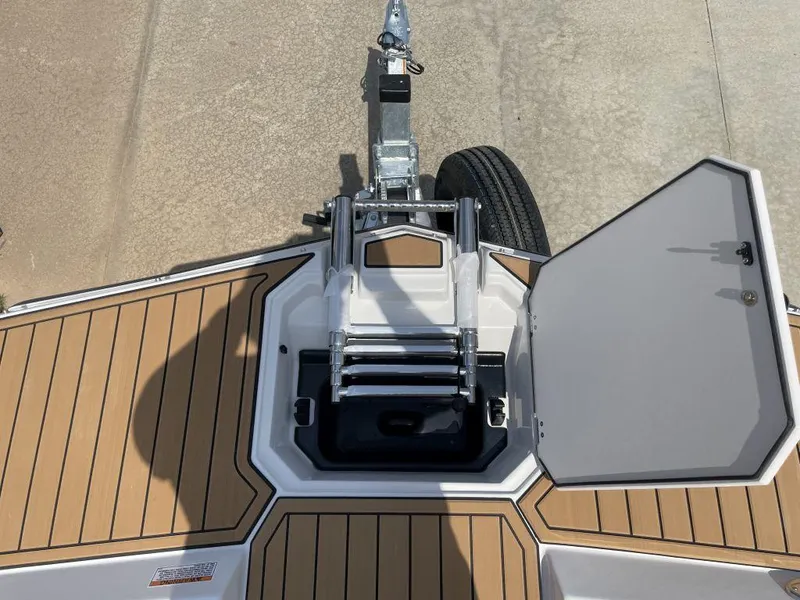 Slide: The Image of 2025 Starcraft SVX 171 OB boat deck with open hatch and ladder. - 16