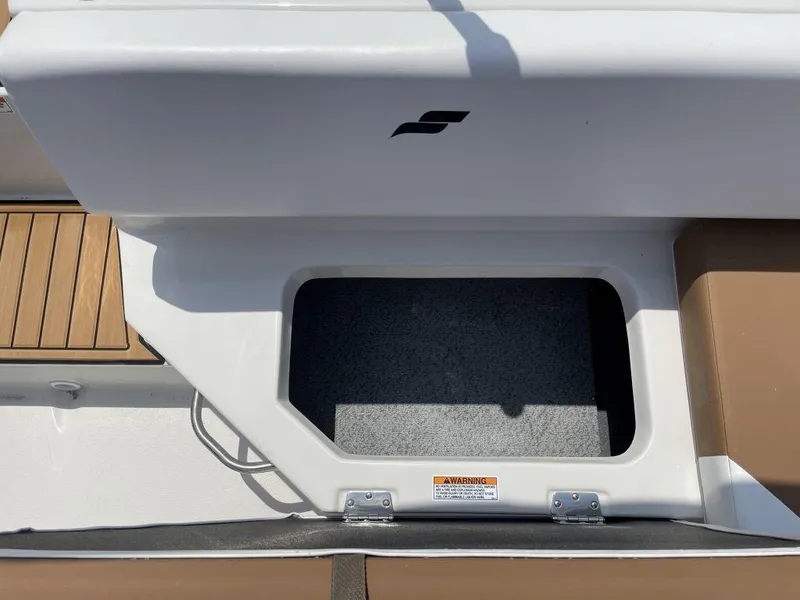 Slide: The Image of Storage compartment on 2025 Starcraft SVX 171 OB boat, featuring sleek design and wood accents. - 18