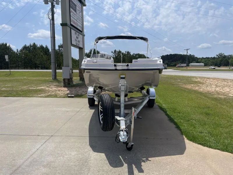Slide: The Image of 2025 Starcraft SVX 171 OB boat on trailer, parked outdoors on a sunny day. - 2