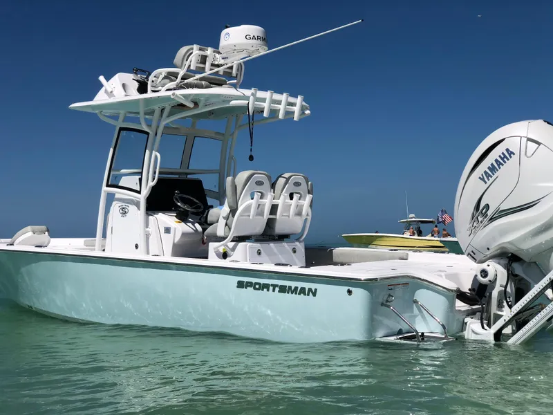 Slide: The Image of 2020 Sportsman Masters 267 Bay Boat with Yamaha engine on clear water. - 2