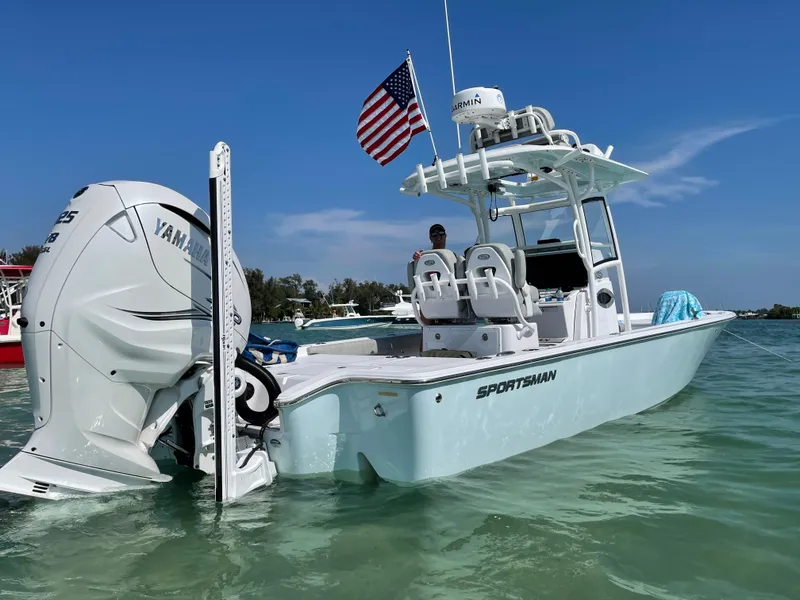Slide: The Image of 2020 Sportsman Masters 267 Bay Boat in clear water, American flag flying. - 3