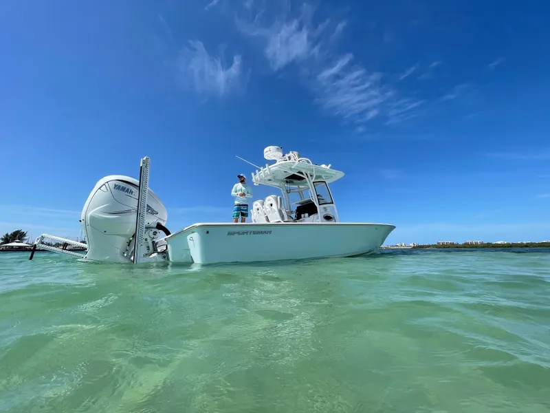 Slide: The Image of 2020 Sportsman Masters 267 Bay Boat on clear water under blue sky. - 4