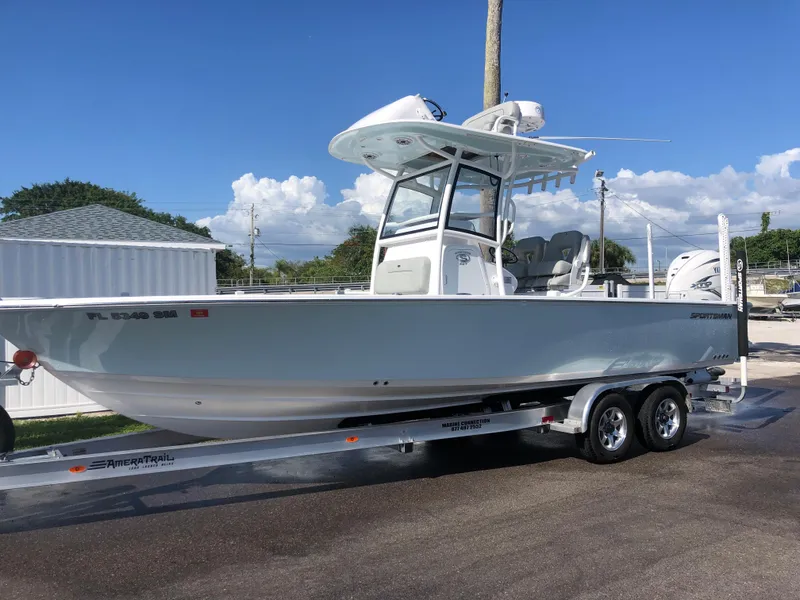 Slide: The Image of 2020 Sportsman Masters 267 Bay Boat on trailer, parked outdoors under clear blue sky. - 6