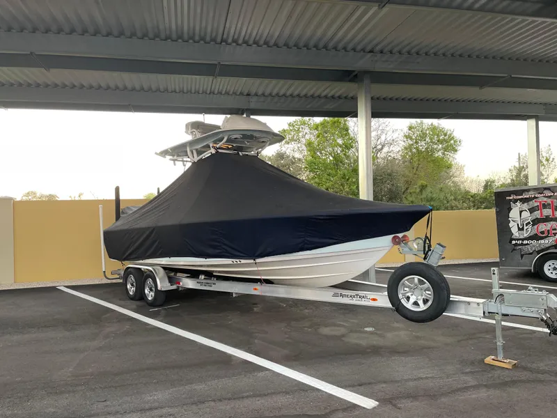 Slide: The Image of 2020 Sportsman Masters 267 Bay Boat covered on trailer in parking area. - 7