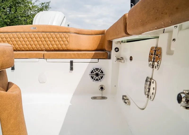 Slide: The Image of 2025 Sea Hunt Ultra 255 SE boat interior with tan upholstery and stainless steel fittings. - 12