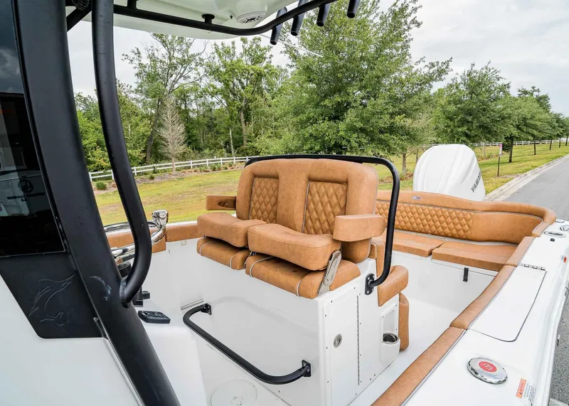Slide: The Image of 2025 Sea Hunt Ultra 255 SE boat interior with tan leather seating and modern design. - 15