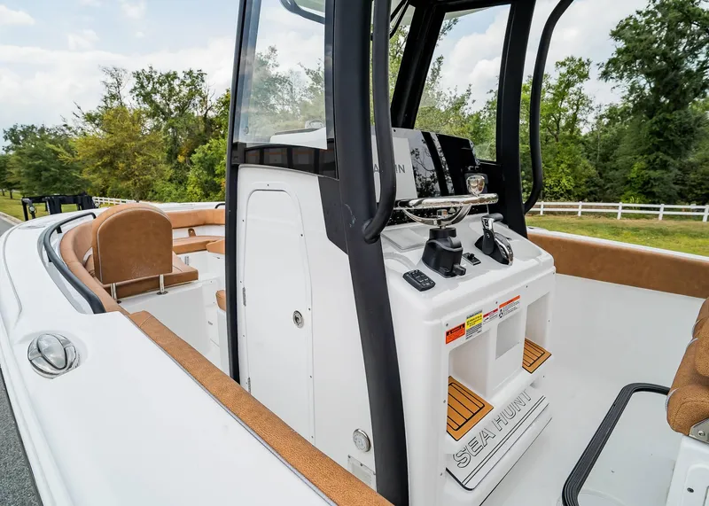 Slide: The Image of 2025 Sea Hunt Ultra 255 SE boat interior with helm and seating. - 17