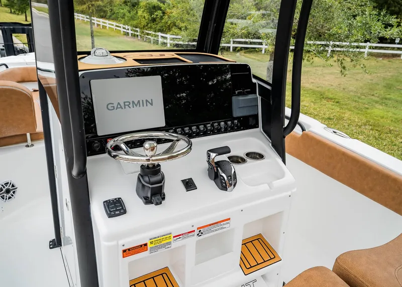 Slide: The Image of 2025 Sea Hunt Ultra 255 SE boat dashboard with Garmin navigation system. - 19