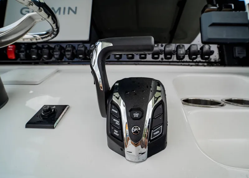 Slide: The Image of 2025 Sea Hunt Ultra 255 SE boat control panel with throttle and Garmin display. - 20