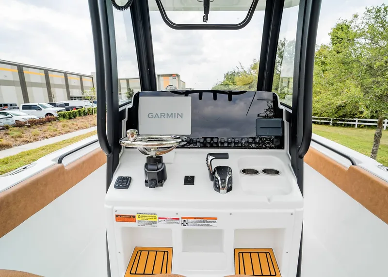 Slide: The Image of 2025 Sea Hunt Ultra 255 SE boat dashboard with Garmin navigation system. - 21