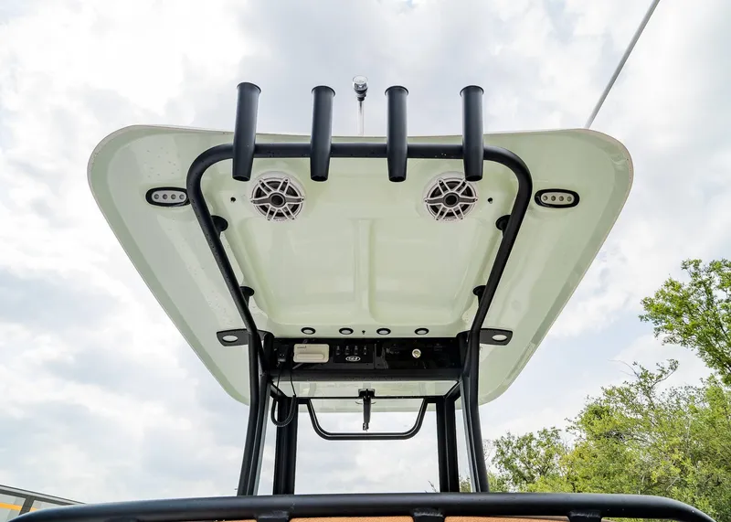 Slide: The Image of 2025 Sea Hunt Ultra 255 SE boat T-top with rod holders and speakers. - 23