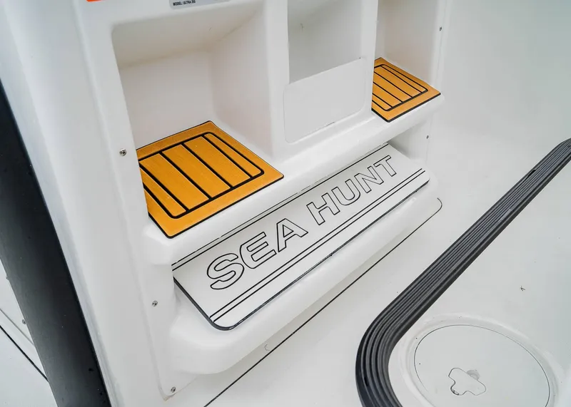 Slide: The Image of 2025 Sea Hunt Ultra 255 SE boat interior with branded step and non-slip surfaces. - 24
