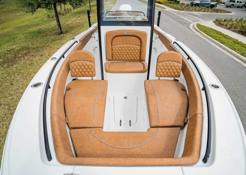 Slide: The Image of 2025 Sea Hunt Ultra 255 SE boat with luxurious tan seating and spacious deck. - 25