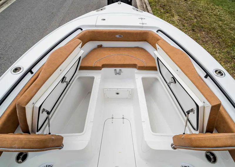 Slide: The Image of 2025 Sea Hunt Ultra 255 SE boat interior with tan seating and storage compartments. - 27