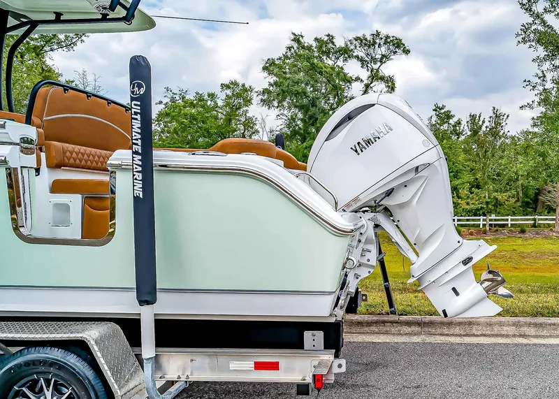 Slide: The Image of 2025 Sea Hunt Ultra 255 SE boat with Yamaha outboard motor on a trailer. - 3