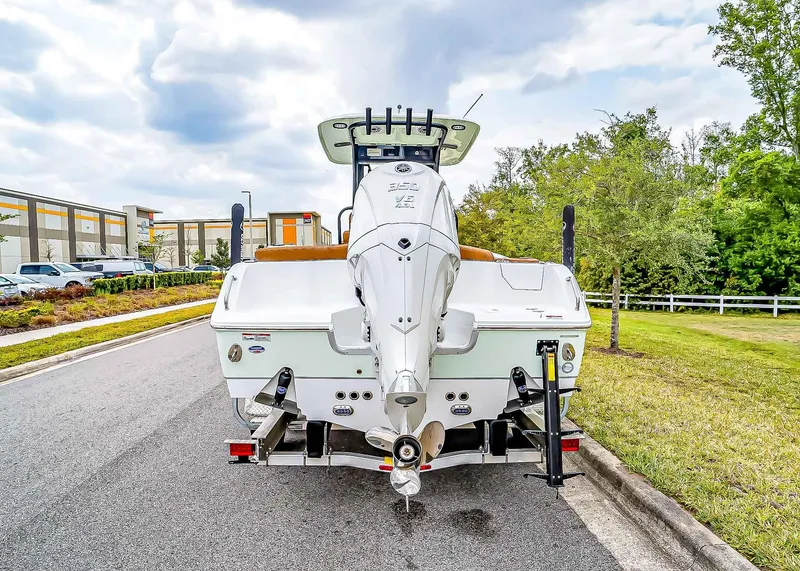 Slide: The Image of 2025 Sea Hunt Ultra 255 SE boat on trailer, parked on roadside. - 4
