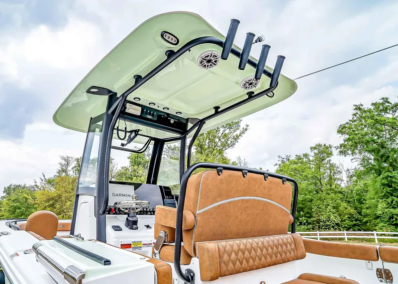 Slide: The Image of 2025 Sea Hunt Ultra 255 SE boat interior with tan seating and advanced navigation equipment. - 5