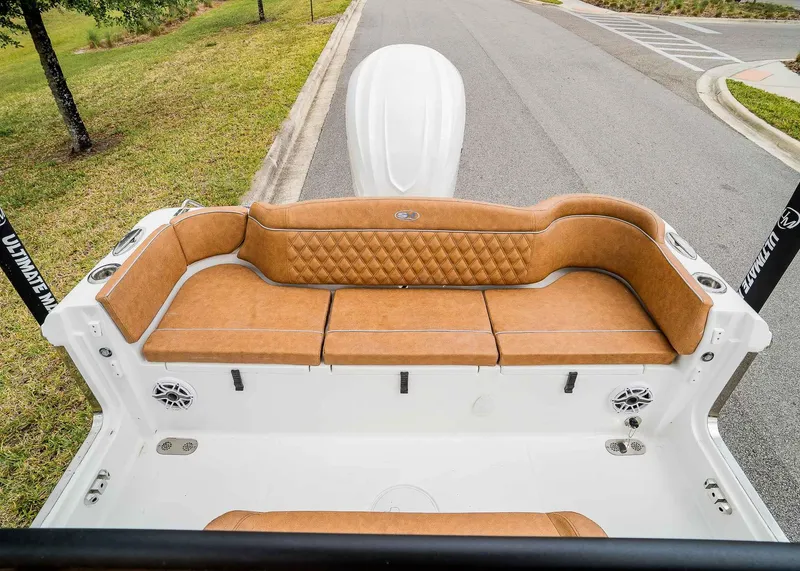Slide: The Image of 2025 Sea Hunt Ultra 255 SE boat with tan cushioned seating and sleek design. - 6
