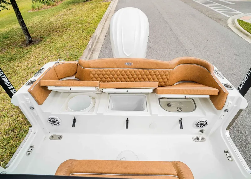 Slide: The Image of 2025 Sea Hunt Ultra 255 SE boat interior with tan seating and storage compartments. - 7