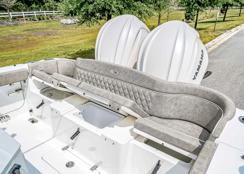 Slide: The Image of 2025 Sea Hunt Ultra 275 SE boat interior with cushioned seating and Yamaha engines. - 13