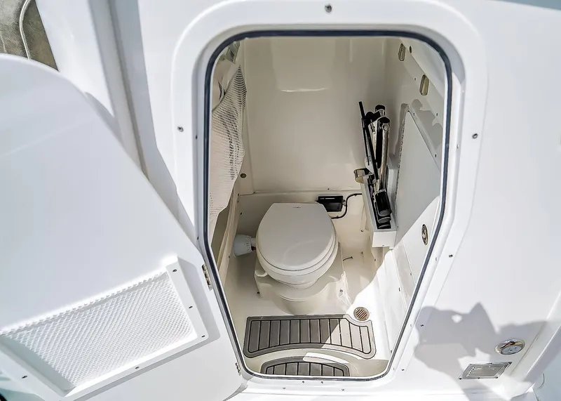 Slide: The Image of Interior view of 2025 Sea Hunt Ultra 275 SE boat bathroom with toilet and storage. - 20