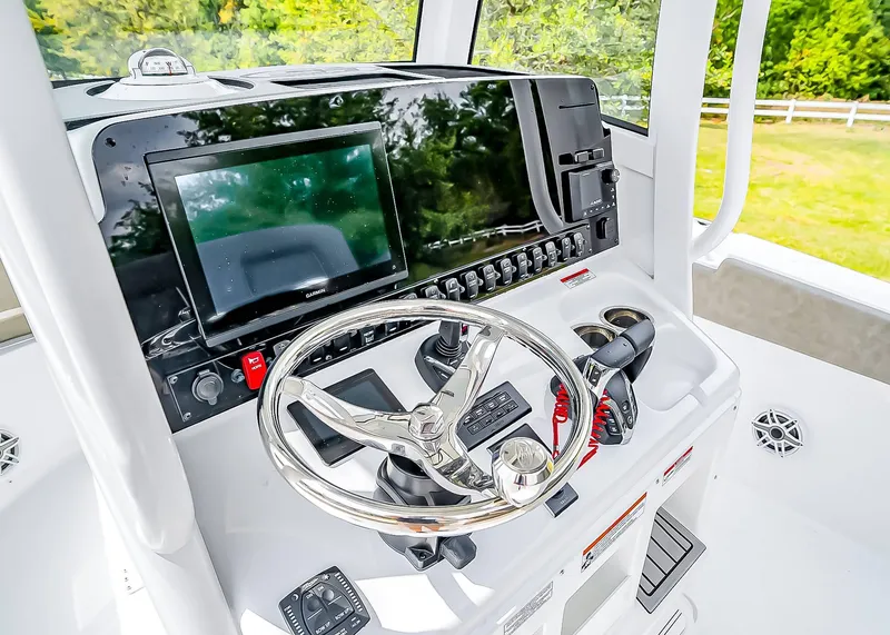 Slide: The Image of Helm of 2025 Sea Hunt Ultra 275 SE with modern controls and navigation display. - 22