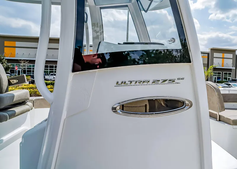 Slide: The Image of 2025 Sea Hunt Ultra 275 SE boat console with seating, outdoors. - 25