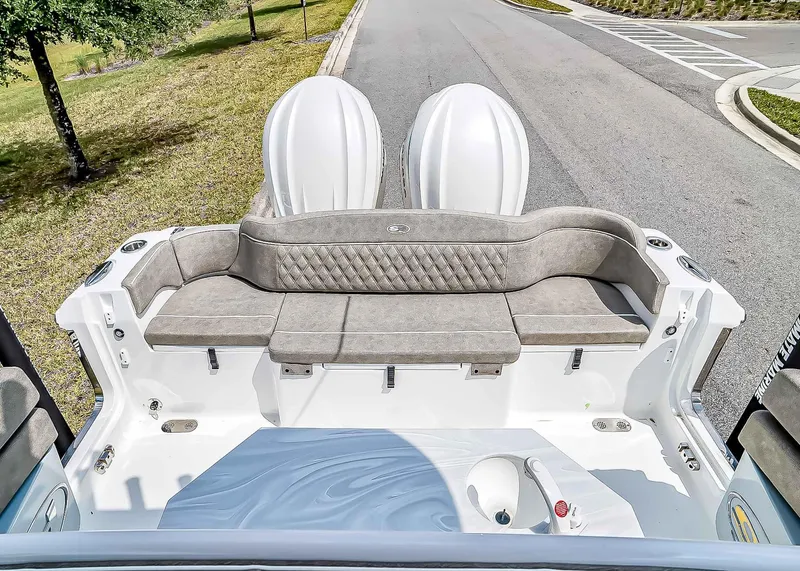 Slide: The Image of 2025 Sea Hunt Ultra 275 SE boat with cushioned seating and dual engines. - 7