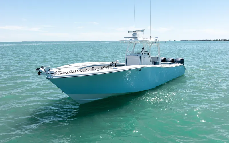 Slide: The Image of 2019 Yellowfin 36 boat on calm blue water, clear sky background. - 10