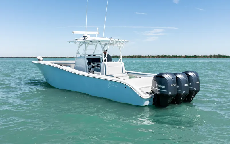 Slide: The Image of 2019 Yellowfin 36 boat with triple Yamaha engines on calm water. - 12