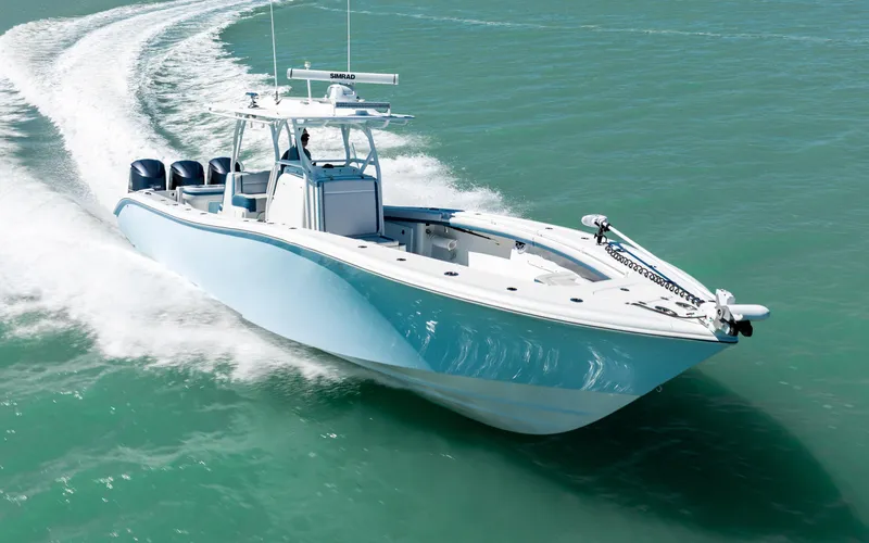 Slide: The Image of 2019 Yellowfin 36 boat cruising on clear turquoise water. - 2