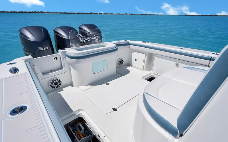 Slide: The Image of 2019 Yellowfin 36 boat with triple outboard engines on clear blue water. - 25